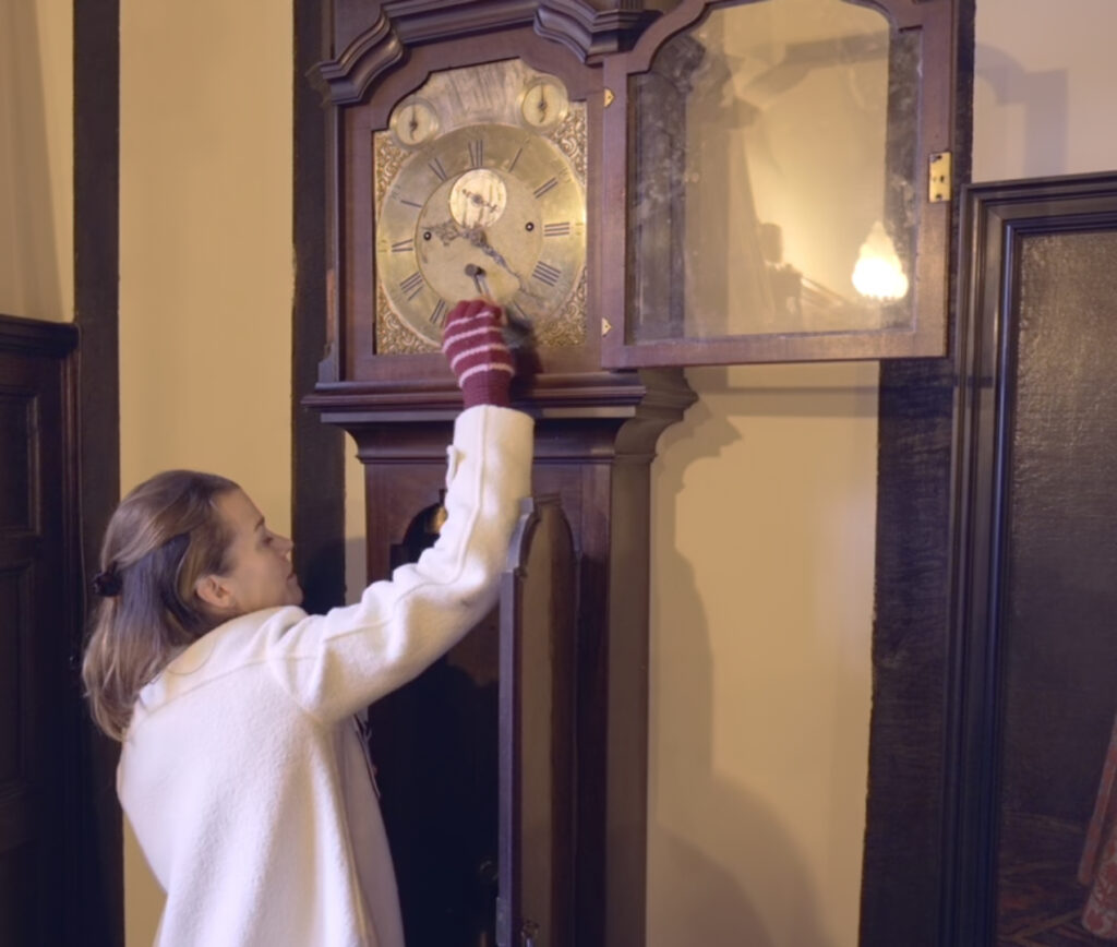 Girl is moving Grandfather Clock
