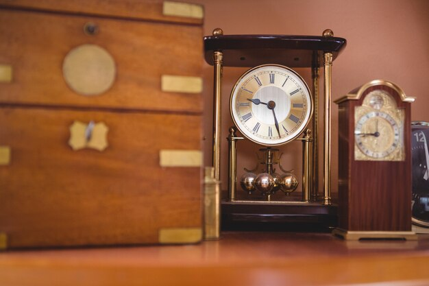 An antique clock standing on a table