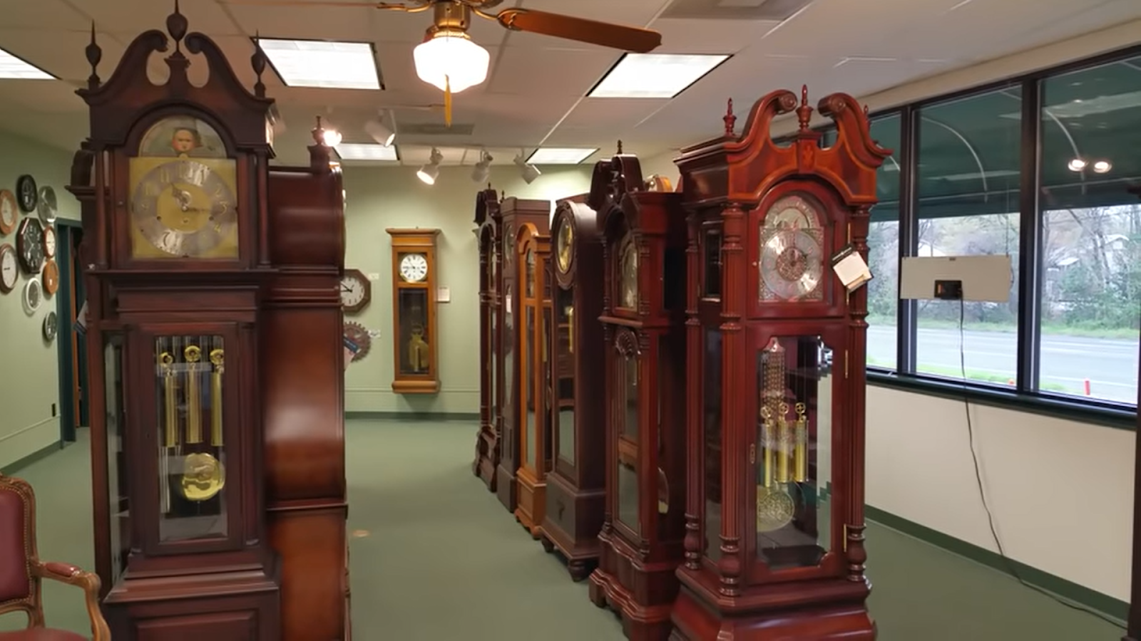 ridgeway grandfather clocks in the room with windows, white light on the ceiling above